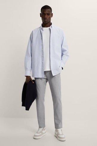Light Blue Vertical Striped Long Sleeve Shirt Outfits For Men: A light blue vertical striped long sleeve shirt and grey chinos are the kind of a fail-safe off-duty ensemble that you need when you have zero time. White leather low top sneakers will tie the whole thing together.