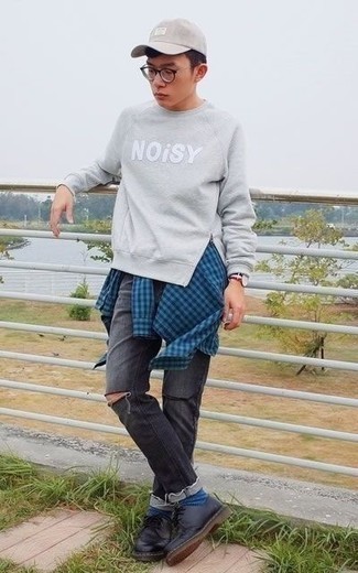 Grey Print Sweatshirt Outfits For Men: This laid-back combo of a grey print sweatshirt and charcoal ripped jeans is capable of taking on different forms depending on the way you style it out. A pair of black leather derby shoes effortlessly amps up the classy factor of this look.
