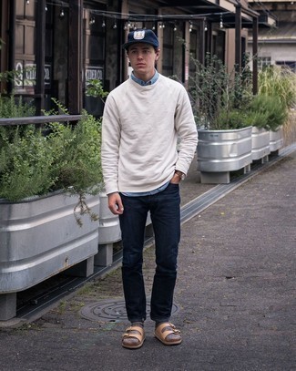 Beige Sweatshirt Outfits For Men: Try teaming a beige sweatshirt with navy jeans to put together a day-to-day ensemble that's full of charm and personality. Finishing off with tan leather sandals is a surefire way to introduce a hint of stylish effortlessness to this look.
