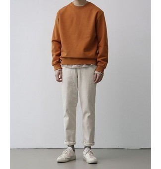 Orange Sweatshirt Outfits For Men: This combination of an orange sweatshirt and white chinos is on the casual side yet it's also stylish and extra stylish. We're totally digging how cohesive this outfit looks when rounded off with a pair of white canvas low top sneakers.