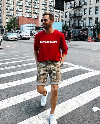 Red Sweatshirt Outfits For Men: A red sweatshirt and olive camouflage shorts are amazing menswear essentials that will integrate nicely within your current casual lineup. If not sure as to the footwear, stick to white leather low top sneakers.