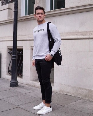 Black Canvas Tote Bag Outfits For Men: The versatility of a grey print sweatshirt and a black canvas tote bag guarantees you'll always have them on high rotation in your closet. And if you wish to immediately step up this outfit with footwear, introduce white and black canvas low top sneakers to this outfit.