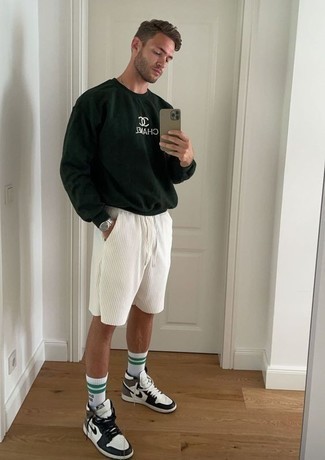 Men's Outfits 2022: Busy off-duty days require a straightforward yet casually stylish look, such as a dark green print sweatshirt and white sports shorts. White and black leather high top sneakers are a smart pick to complement your look.