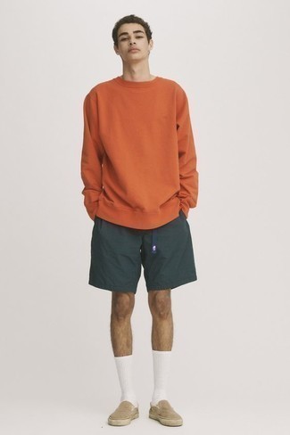 Orange Sweatshirt Outfits For Men: Consider teaming an orange sweatshirt with dark green sports shorts to pull together an interesting and modern casual outfit. Complete this getup with beige canvas slip-on sneakers to instantly switch up the outfit.