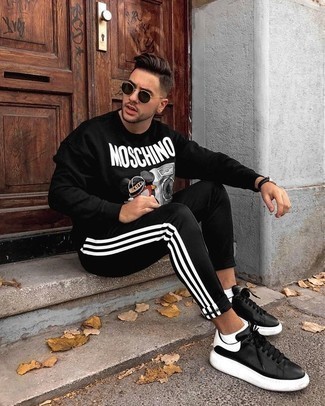 Black and White Vertical Striped Sweatpants Outfits For Men: This casual combo of a black print sweatshirt and black and white vertical striped sweatpants is simple, stylish and super easy to copy. Black and white leather low top sneakers are guaranteed to bring an extra dose of class to your ensemble.