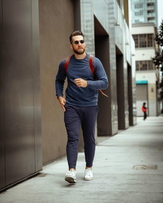 Navy Sweatshirt Outfits For Men: This street style pairing of a navy sweatshirt and navy sweatpants is super easy to put together without a second thought, helping you look awesome and ready for anything without spending a ton of time searching through your wardrobe. The whole outfit comes together perfectly when you complement your outfit with a pair of white canvas low top sneakers.