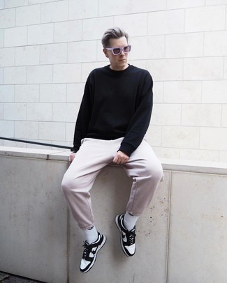Light Violet Sunglasses Outfits For Men: Team a black sweatshirt with light violet sunglasses to put together an interesting and bold casual outfit. White and black leather low top sneakers are guaranteed to breathe an added dose of style into your look.