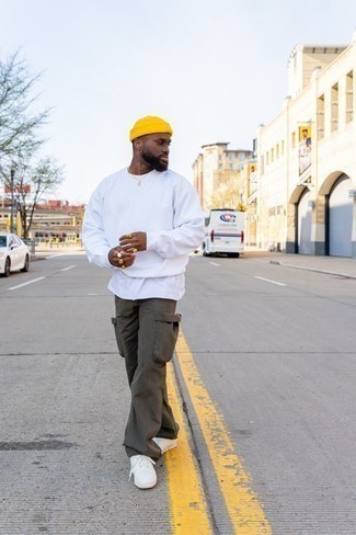 White Sweatshirt Outfits For Men: A white sweatshirt and brown cargo pants are veritable menswear essentials if you're crafting an off-duty closet that matches up to the highest fashion standards. If you're clueless about how to finish off, finish off with white canvas low top sneakers.