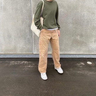 Sweatshirt Outfits For Men: Wear a sweatshirt with khaki chinos for comfort dressing with a twist. White canvas low top sneakers will tie this whole outfit together.
