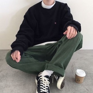 Black Sweatshirt Outfits For Men: Flaunt that you know a thing or two about men's style by wearing a black sweatshirt and dark green chinos. Introduce black and white canvas low top sneakers to the mix and ta-da: the outfit is complete.