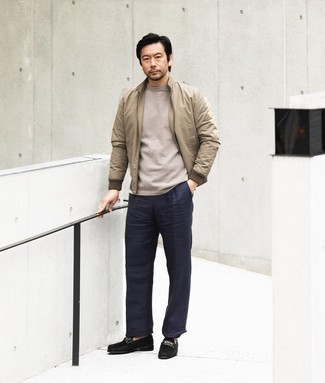 Navy Chinos Outfits: For something more on the cool and laid-back side, wear this pairing of a tan bomber jacket and navy chinos. Channel your inner David Beckham and complement your ensemble with black suede loafers.