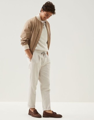 Tan Bomber Jacket Outfits For Men: If you're looking for a laid-back but also on-trend outfit, dress in a tan bomber jacket and white chinos. Rounding off with dark brown leather tassel loafers is a surefire way to bring a bit of fanciness to your getup.