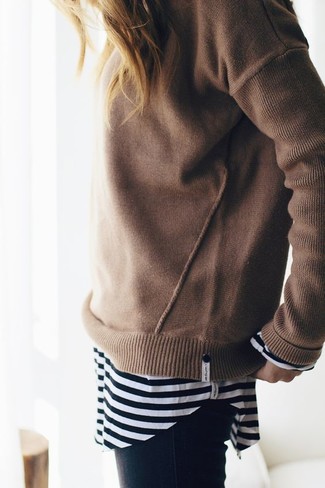 For a laid-back outfit with a modern take, pair a tan crew-neck sweater with black skinny jeans.