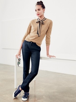 Black Chinos with Low Top Sneakers Outfits For Women: This laid-back pairing of a tan crew-neck sweater and black chinos comes in useful when you need to look stylish in a flash. A pair of low top sneakers finishes off this look very well.