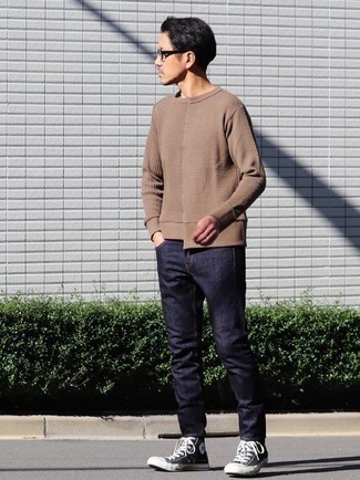 Beige Crew-neck Sweater Casual Outfits For Men: A beige crew-neck sweater and navy jeans paired together are a sartorial dream for those dressers who love casual outfits. Let your outfit coordination savvy truly shine by rounding off this outfit with a pair of black and white canvas high top sneakers.