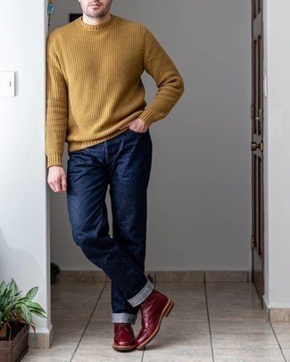 Tan Crew-neck Sweater Outfits For Men: This outfit with a tan crew-neck sweater and navy jeans isn't a hard one to pull off and is open to more creative experimentation. Get a bit experimental when it comes to footwear and add burgundy leather casual boots to the equation.