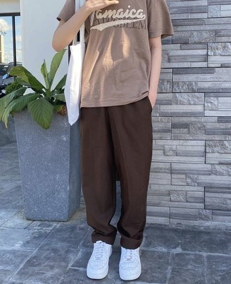Dark Brown Chinos Outfits: To assemble a relaxed casual getup with a twist, team a tan print crew-neck t-shirt with dark brown chinos. Complement this look with white leather low top sneakers and the whole ensemble will come together.