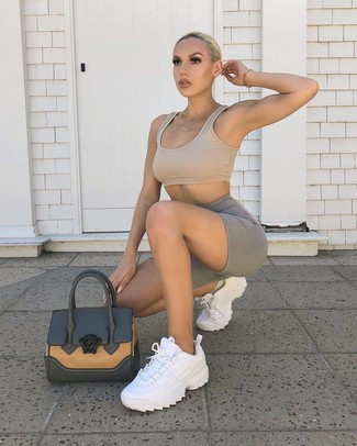 500+ Relaxed Outfits For Women: This relaxed casual combination of a tan cropped top and grey bike shorts is a real life saver when you need to look cool in a flash. Serve a little outfit-mixing magic by sporting white athletic shoes.