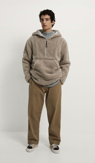 Beige Fleece Hoodie Outfits For Men: This combo of a beige fleece hoodie and brown chinos is irrefutable proof that a safe off-duty look doesn't have to be boring. This getup is completed really well with a pair of multi colored canvas low top sneakers.
