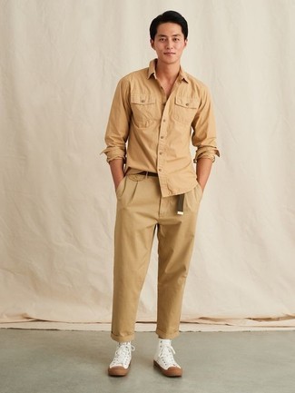 Tobacco Canvas Belt Outfits For Men: A tan long sleeve shirt and a tobacco canvas belt teamed together are a match made in heaven for guys who appreciate casually cool styles. Complete this outfit with white canvas high top sneakers to serve a little outfit-mixing magic.