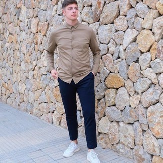 Tan Long Sleeve Shirt Outfits For Men: Choose a tan long sleeve shirt and navy chinos and you'll be ready for whatever this day has in store for you. For times when this outfit appears too polished, dress it down by rocking a pair of white leather low top sneakers.