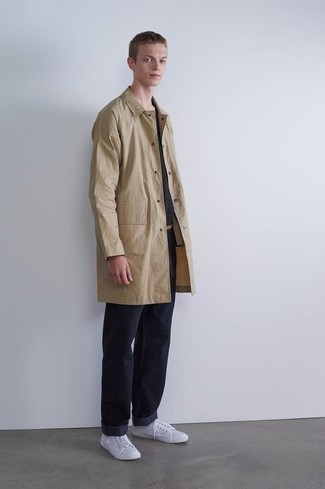 Beige Raincoat Outfits For Men: Consider teaming a beige raincoat with navy jeans to assemble an incredibly sharp and modern-looking relaxed ensemble. The whole ensemble comes together if you add a pair of white canvas low top sneakers to your outfit.
