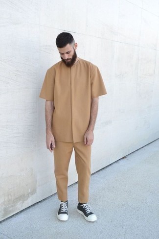 Tan Short Sleeve Shirt Outfits For Men: Wear a tan short sleeve shirt and khaki chinos if you seek to look laid-back and cool without too much effort. Black and white canvas low top sneakers are a stylish addition to this look.