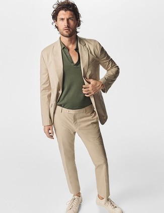 Olive Polo Outfits For Men: Go for an olive polo and a tan suit for a proper elegant outfit. Power up your ensemble with beige leather low top sneakers.