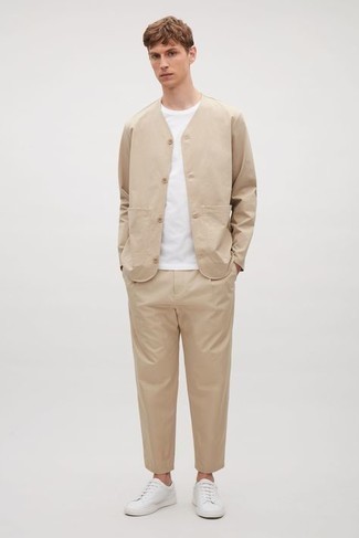 Tan Suit Outfits: This combo of a tan suit and a white crew-neck t-shirt looks well-executed and immediately makes you look dapper. Introduce a touch of stylish effortlessness to by rocking a pair of white canvas low top sneakers.
