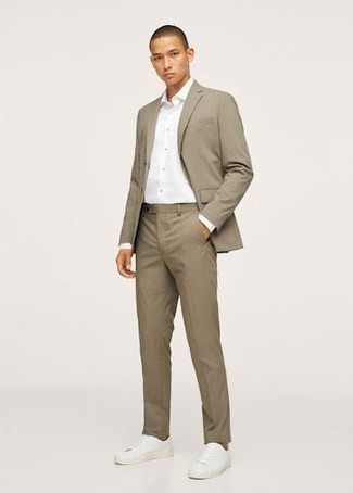 Tan Suit Outfits In Their 20s: You're looking at the hard proof that a tan suit and a white dress shirt look amazing when married together in a refined outfit for a modern gent. You can get a bit experimental in the shoe department and play down this look by wearing a pair of white canvas low top sneakers. As you're transitioning from your 20s to your 30s, you want to start dressing with more refinement. In this case, combos like this are ideal as inspiration.