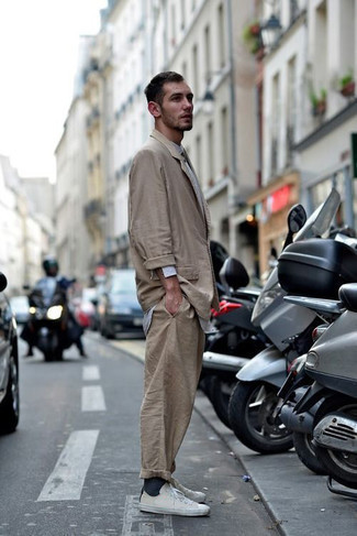 Beige Sneakers Outfits For Men: Go for something smart yet trendy in a tan suit and a white long sleeve shirt. And if you wish to immediately dress down your look with one piece, complement your getup with beige sneakers.