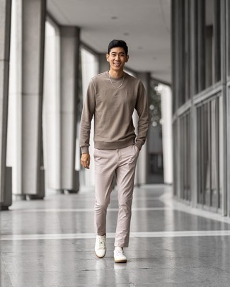 Beige Chinos Outfits: This casual pairing of a tan sweatshirt and beige chinos is extremely easy to pull together without a second thought, helping you look amazing and ready for anything without spending a ton of time combing through your wardrobe. If you're on the fence about how to finish, round off with white canvas low top sneakers.