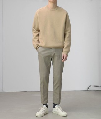Beige Sweatshirt Outfits For Men: If you're in search of a laid-back but also on-trend getup, pair a beige sweatshirt with grey chinos. A pair of white leather low top sneakers acts as the glue that pulls your ensemble together.
