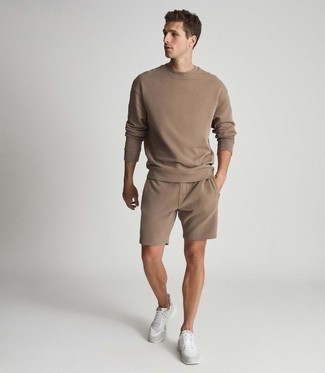 Beige Sports Shorts Outfits For Men: This bold casual pairing of a tan sweatshirt and beige sports shorts is extremely easy to put together without a second thought, helping you look seriously stylish and prepared for anything without spending too much time going through your wardrobe. A pair of white athletic shoes looks perfectly at home here.