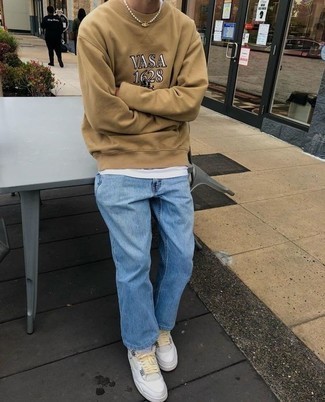 Tan Print Sweatshirt Outfits For Men: For relaxed dressing with a modern spin, team a tan print sweatshirt with light blue jeans. Complement your look with white canvas low top sneakers and the whole getup will come together brilliantly.