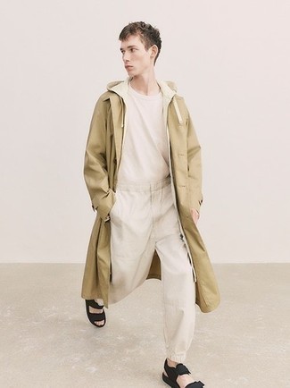 Tan Track Suit Outfits For Men: A tan track suit and a tan trenchcoat worn together are a sartorial dream for gentlemen who prefer casual outfits. For a more casual touch, why not complete this getup with black canvas sandals?