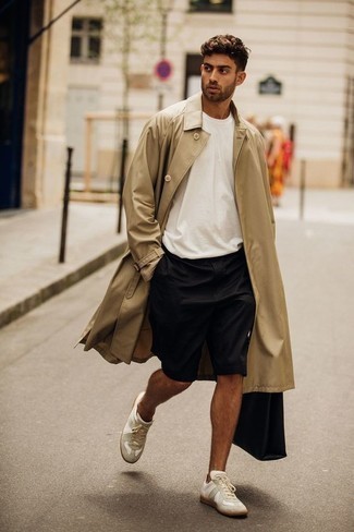 Beige Trenchcoat Outfits For Men: This combination of a beige trenchcoat and black shorts is certainly impactful, but it's also extremely easy to achieve. Infuse a more relaxed aesthetic into this outfit by rocking white canvas low top sneakers.