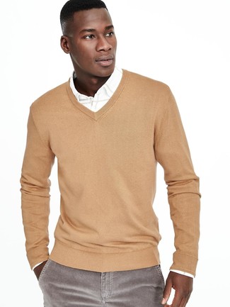 Tan V-neck Sweater Outfits For Men: A tan v-neck sweater and grey corduroy jeans combined together are a sartorial dream for gentlemen who love casually cool styles.
