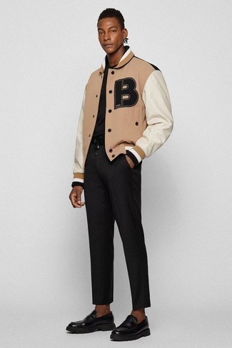 Varsity Jacket Outfits For Men: The formula for a kick-ass casual ensemble for men? A varsity jacket with black chinos. Puzzled as to how to finish your look? Wear black chunky leather loafers to step up the fashion factor.