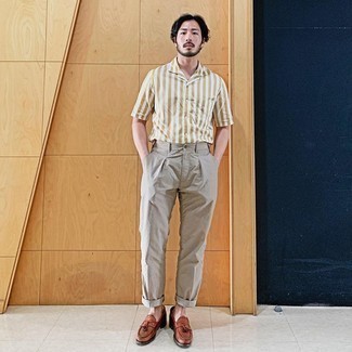 Beige Chinos Smart Casual Outfits: A big thumbs up to this laid-back combination of a tan vertical striped short sleeve shirt and beige chinos! Introduce a pair of tobacco leather tassel loafers to the mix to avoid looking too casual.