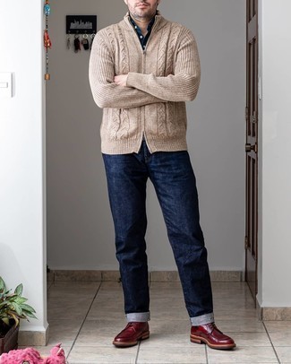 Red Leather Casual Boots Outfits For Men: This pairing of a tan knit zip sweater and navy jeans is proof that a safe casual ensemble doesn't have to be boring. Complete this getup with a pair of red leather casual boots for an added touch of class.