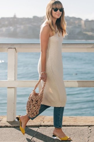 Women's Outfits 2022: This casual combo of a beige knit tank dress and blue jeans is a fail-safe option when you need to look stylish but have no extra time. Finish off with a pair of yellow leather mules to va-va-voom this outfit.