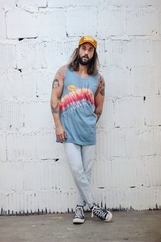 Mustard Baseball Cap Outfits For Men: This urban combo of a light blue tie-dye tank and a mustard baseball cap is extremely easy to throw together in no time, helping you look on-trend and ready for anything without spending too much time rummaging through your wardrobe. Get a little creative with shoes and elevate this ensemble by finishing with a pair of navy and white canvas high top sneakers.