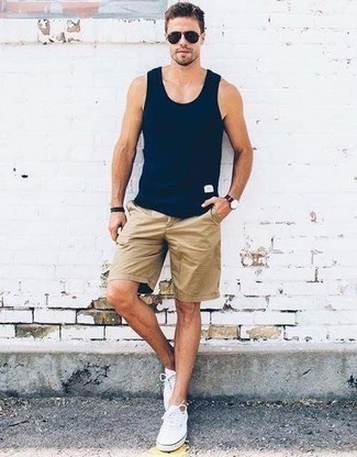 Navy and White Canvas Watch Outfits For Men: Perfect off-duty in a navy tank and a navy and white canvas watch. Rounding off with white canvas low top sneakers is the most effective way to introduce a bit of classiness to your look.