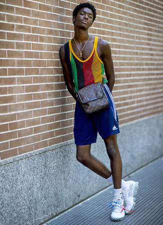 Multi colored Tank Outfits For Men: A multi colored tank and blue sports shorts are a casual pairing that every fashion-forward gentleman should have in his closet. Look at how well this ensemble pairs with white athletic shoes.