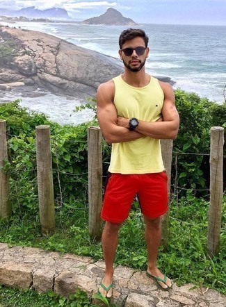 Yellow Tank Outfits For Men: Dress in a yellow tank and red sports shorts if you're hunting for a look option that conveys relaxed cool. Finishing with green flip flops is a surefire way to inject a fun touch into your outfit.