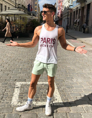 White Print Tank Outfits For Men: A white print tank and mint sports shorts are a casual street style combination that every style-conscious gentleman should have in his wardrobe. To bring a bit of classiness to your ensemble, complete your ensemble with white canvas high top sneakers.