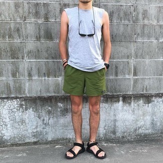 Men's Outfits 2021: A grey tank and olive sports shorts are an easy way to introduce effortless cool into your off-duty styling repertoire. For something more on the daring side to finish your outfit, complement your getup with black canvas sandals.
