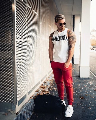 White and Red Print Tank Outfits For Men: A white and red print tank and red sweatpants are a great combination to have in your casual repertoire. Want to go all out with footwear? Add white canvas low top sneakers to this ensemble.