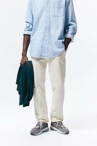 Aquamarine Denim Shirt Outfits For Men: This is indisputable proof that an aquamarine denim shirt and beige chinos look awesome when worn together in an off-duty look. Play down this ensemble by slipping into a pair of grey athletic shoes.